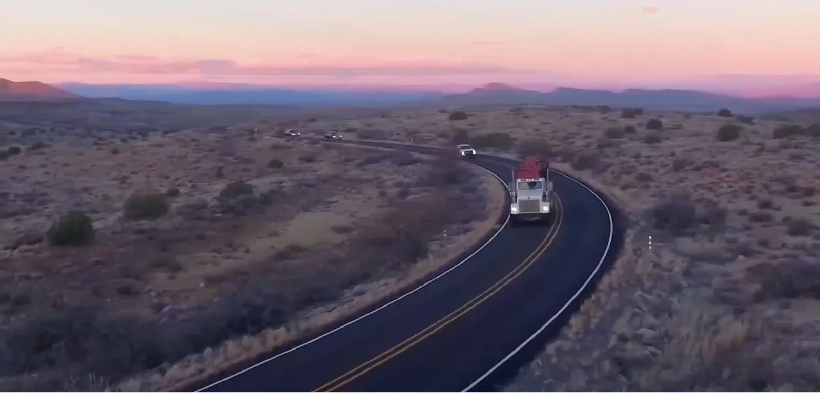 The test convoy on the desert highway at dusk